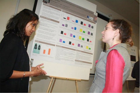 Ohio University graduate student Amrita Basu discusses her research on growth hormone and neurodegenerative diseases with West Virginia University student Polina Kozyulina. Basu won second place in the poster presentation competition.