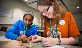 Shifra Narasimhan, left and Abigail Tadlock learn to build a simple circuit during the Tech Savvy workshop at Ohio University May 17, 2014. The event exposes girls from sixth through ninth grade to thee field of science, technology, engineering and math. Photo by Ohio University / Jonathan Adams
