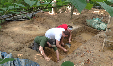 Working side at the excavation site by side are left to right Nicholas Stillman, Jonathon Yochum, and Natasha Cromwell. 