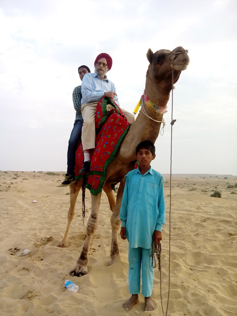 Dr. Amrit Singh rides a camel in the Jaisalmer sand dunes on Nov 2. The ride took place soon after a beautiful sunrise, after a drive from the town of Jaisalmer to the village of Sam. The camel's name was Shah Rukh Khan.