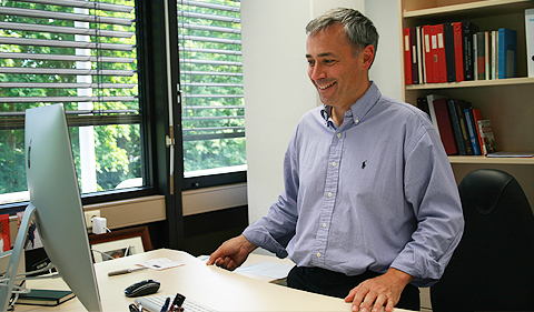 Jairo Sinova in his Mainz office at his ergonomic desk as he provides a tour of his new surroundings