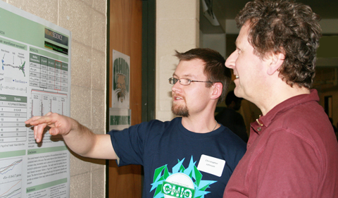 Physics doctoral student Christopher Johnson explains his research to Dr. Peter Jung at a recent Ohio University Student Research and Creative Activity Expo. Johnson presented part of his research at the recent Axonal Transport & Neuronal Mechanics Workshop at OSU.