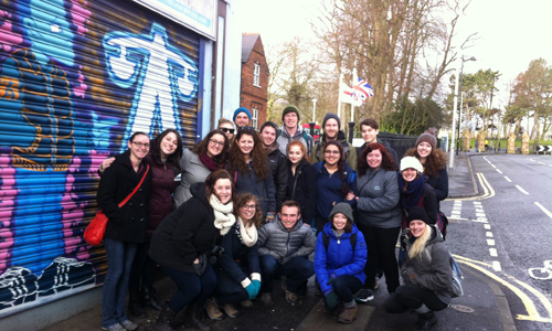 Students pose outside of Alternatives, a community-based restorative justice organization on Shankill Road in Belfast in 2015.