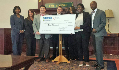 The Ohio Reach Scholars Program grant ceremony. Briana Hervet, Brooke Grant, Tommy Raimondi, Michael Outrich, Jacob Okumu, LaTasha Watts, Kimberly Moore and William Murray pose with the ceremonial $60,000 check from the Ohio Attorney General's Office and the Ohio Reach Board.