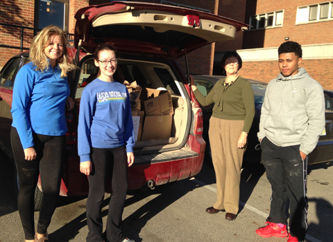 Patricia Davidson of the Shade Community Center with Derrick Grice, Kali Krownapple, Allison Nowak, all in CAS 1300, after they helped load more than 500 pounds of food into Davidson's SUV.