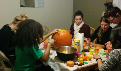 Undergraduate students Mia Johnson, Ellen Smith, Carla Stone, Becca Cherry, Gabbi Atwell, and Nikki Morales create the lab's pumpkin display.