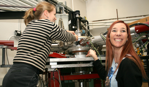 University of Oslo physicists Therese Renstrom and Ann-Cecile Larsen check the time-of-flight energy chamber containing the target and silicon detectors.