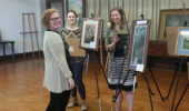 Harlee Rozell with Hailee Fouch and Jessica Cydrus setting up art exhibit at Federal Valley Reserve Center April 14, 2016.