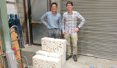 Nuclear Physicists Tony Ahn and Zach Meisel stand on the dock at the Edwards Accelerator Lab and behind section of the polyethylene blocks used to slow down neutrons. The holes are where the detectors are placed.