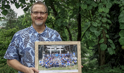 Thompson with a photo taken of participants in the 2015 September edition of the OHIO-IPU Tsunami Relief Project.
