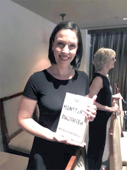 Michelle Pretorius at the Melville House Bookseller's Dinner, where she holds the hardback copy of her debut novel for the first time