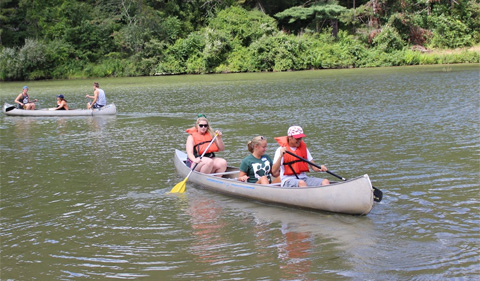 Students study aquatic biology in the field (above) and check out the law at Stroud's Run State Park by canoe (below).