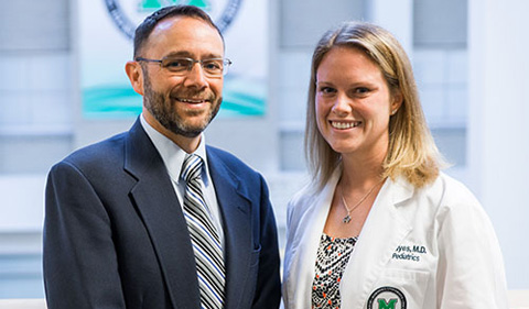 William Nitardy, M.D., presents a plaque to Rebecca Hayes, M.D. Photo by Marshall University.