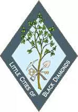 Little Cities of Black Diamond logo, with tree and minors tools in diamond shape