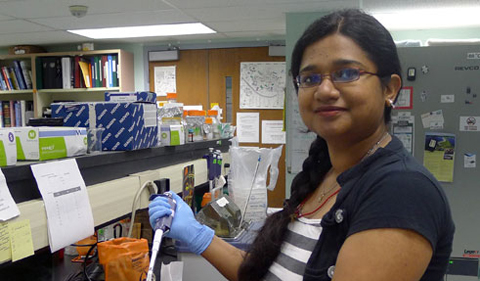 Proma Basu with pipette in the Wyatt lab