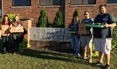 Graduate students Proma Basu, Emily Keil, Laura Mason, Danny Wolf, and Joshua Evans stand outside the Coolville elementary.