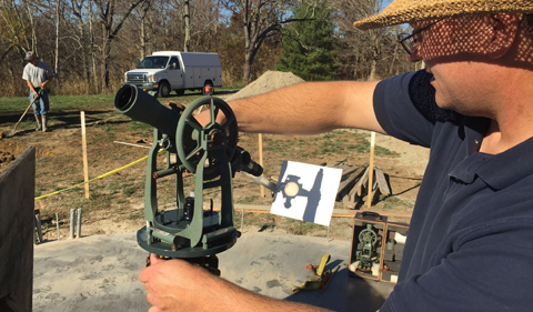 Mike Myers uses a theodolite at the Ohio University Observatory construction site.