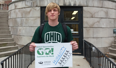 Logan Crum with humanity sign