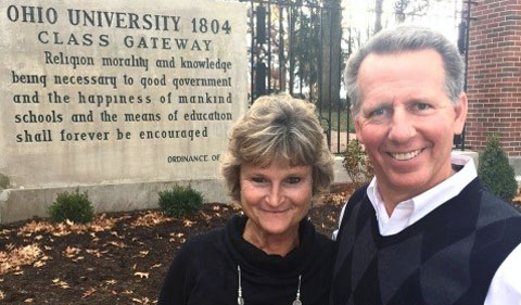 Steve Ellis, right,and his wife in front of the Alumni Gate at Ohio University