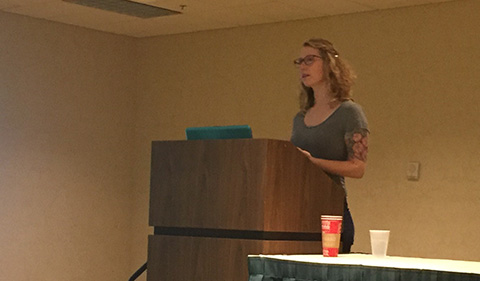 Babz Jewell behind podium presenting research at the American Society of Criminology