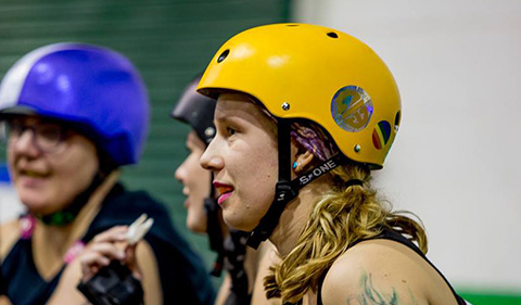 Babz Jewell in her Appalachian Hellbetties team uniform with two other team members