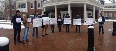 Students protest President Donald Trump's executive order in front of Baker Center.