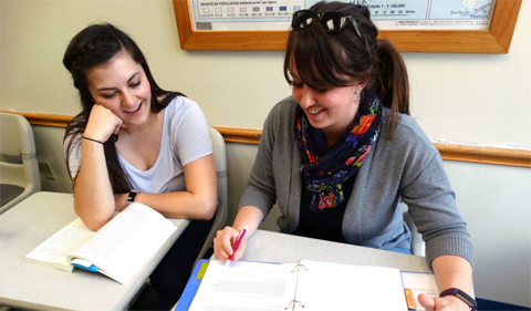 Brooke Stokes (right) and Leanne Ketchum give each other feedback on their latest assignment in ELIP 5160: Writing for Research.
