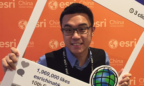 Lo attending the 2015 Asia Pacific User Conference. Man standing in frame with orange background.