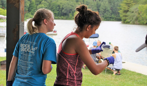Two students sample water at Strouds Run State Park as part of "CSI Athens" during STEMstart.