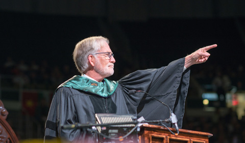 OHIO alum David Crane speaks at gradatue commencement after receiving an honorary doctorate degree from Interim President David Descutner. Photo by Ben Siegel