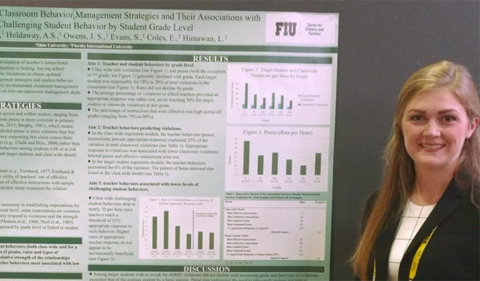 Jessica Smith presents a research poster at the Association for Behavioral and Cognitive Therapies (ABCT) convention, shown here standing by her poster.