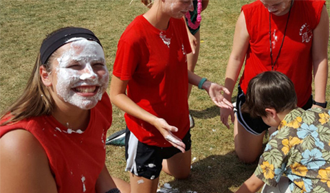 Throwing a pie in the face of a counselor is a favorite reward among campers. Kaylee Tomasek '17 shows off her whipped cream face.