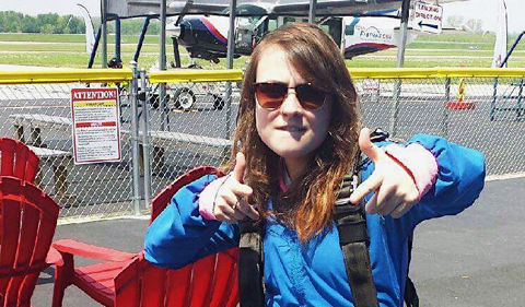 Psychology student Megan Credit, wearing parachute harness at airfield
