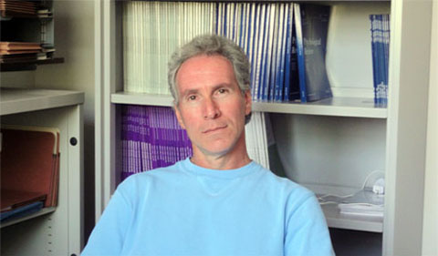 DR. Mark Alicke, seated in his office