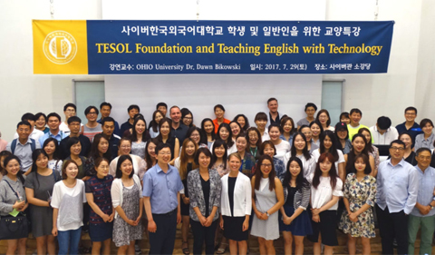 Students gather in South Korea for the TESOL Foundation and Teaching English with Technology conference with Ohio University. Group photo under banner.