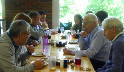 Participants continue the discussion at lunch.