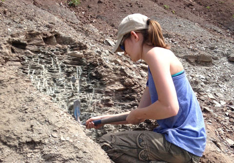 Kelsey McGuire excavating at Site 3.