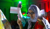 Hams Kashoob, carrying flag from her native Oman.