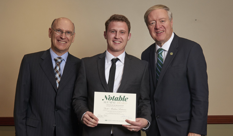 From left, Dean Robert Frank, alum Jake Robertson, and President M. Duane Nellis, with Robertson holding certificate
