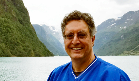 Dr. James Lein, with mountains, lake in background