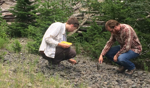 Observing lumps of chromite with student Christian Thomas. Credit: Emma Swaninger