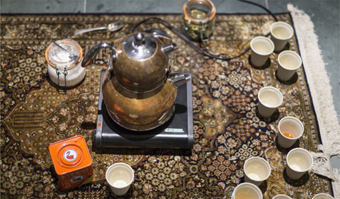 Tea project, with plastic cups on rug. art of the Material Histories: Cultures of Resistance Exhibit
