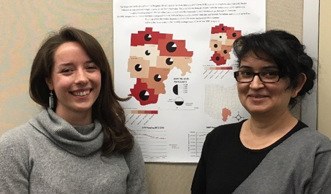 Carolyn Kinzel  and instructor Ana Mojica-Myers (M.A., 2009) with Kinzel’s cartography class project.