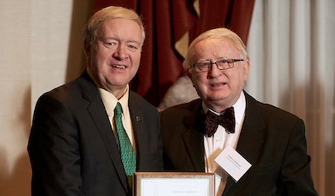 President M. Duane Nellis awards Tadeusz Malinski with a U.S. patent plaque. 