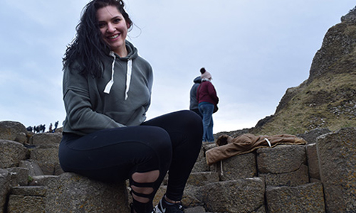 A smiling Abigail Guerra on rock hill on the Giant's Causeway on the Antrim coast of Northern Ireland in March 2018.