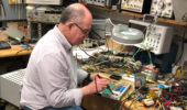 Don Carter repairs a high voltage module for use in powering a particle detector at the Edwards Accelerator Lab.
