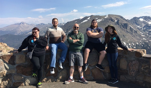 Carroll lab members (some of them). Left to right. Rachel Zapf (graduate student), Marcus Wittekind (undergrad), Dr. Ronan Carroll, Andy Caillet (undergrad), and Emily Trzeciak (HTC undergrad), posing at lookout with Colorado mountains in background.