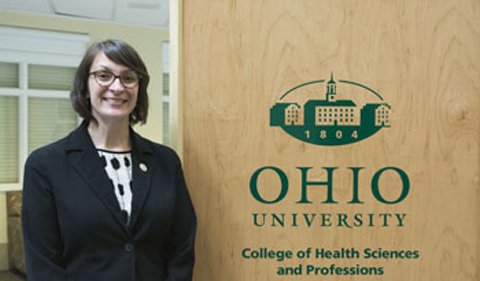 Kerri Shaw , portrait beside sign saying Ohio University College of Health Sciences and Professions