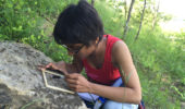 Nilmani Perera MS '17 examines the outcrop of the Ames Limestone on Witches Hill, Athens, Ohio