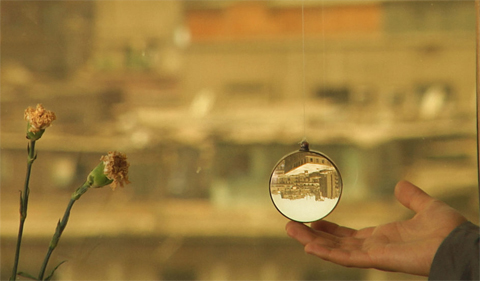 In the Last Days of the City, showing city under a magnifying glass